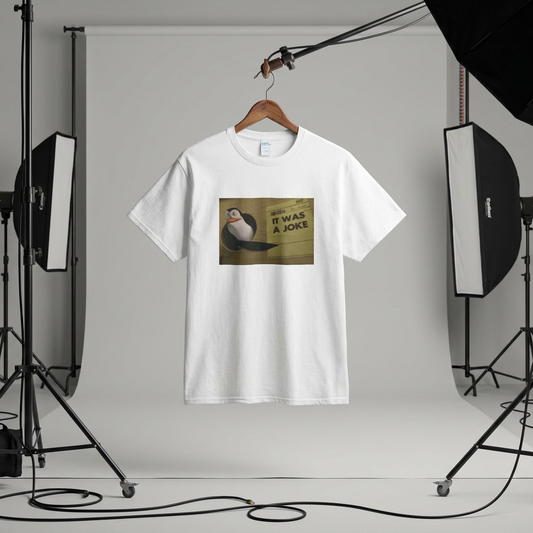 White t-shirt with a graphic design on a hanger against a gray studio backdrop.