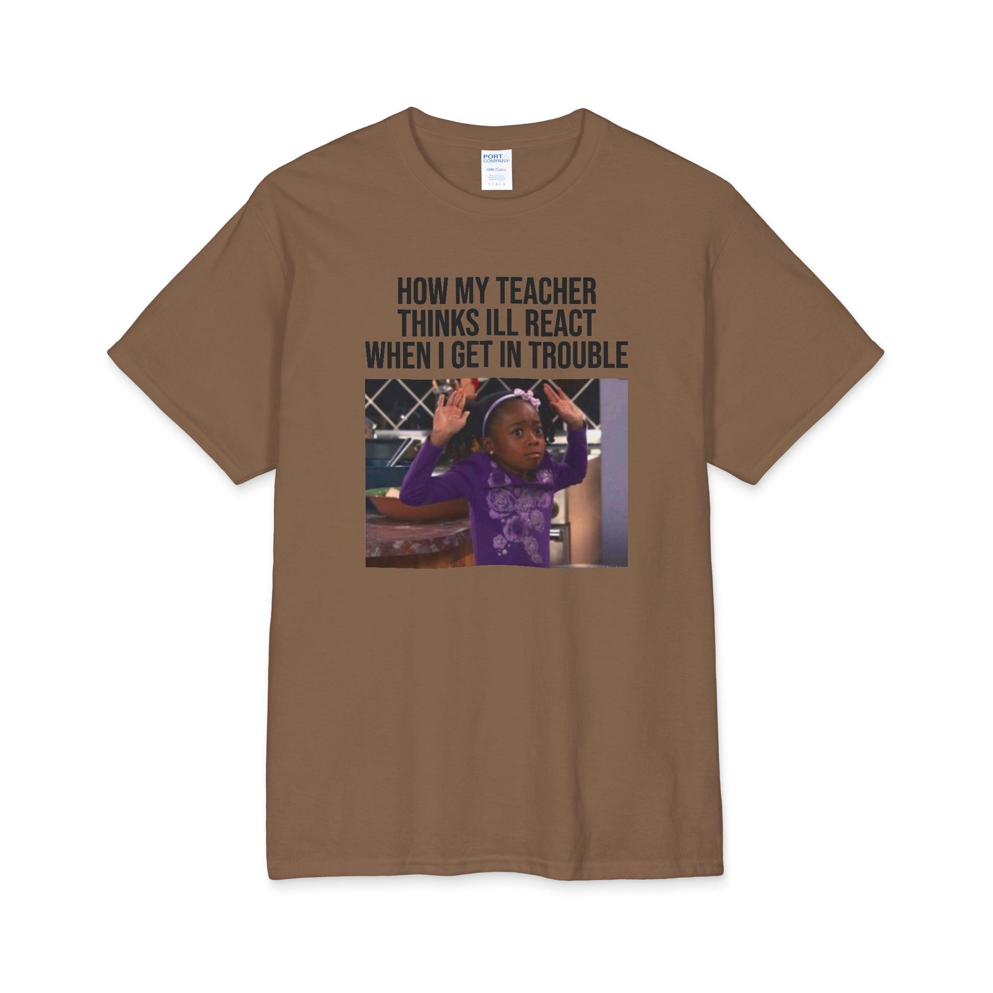 A brown t-shirt with a graphic containing a girl with her hands up and text above the image stating 'How My Teacher Thinks I'll React When I Get In Trouble' on a white background