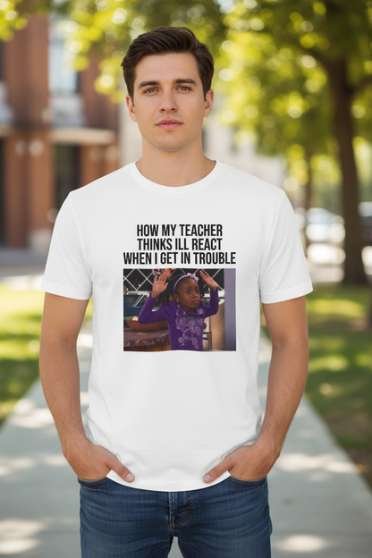 Man wearing a white t-shirt with a graphic containing a girl with her hands up and text above the image stating 'How My Teacher Thinks I'll React When I Get In Trouble', standing outdoors