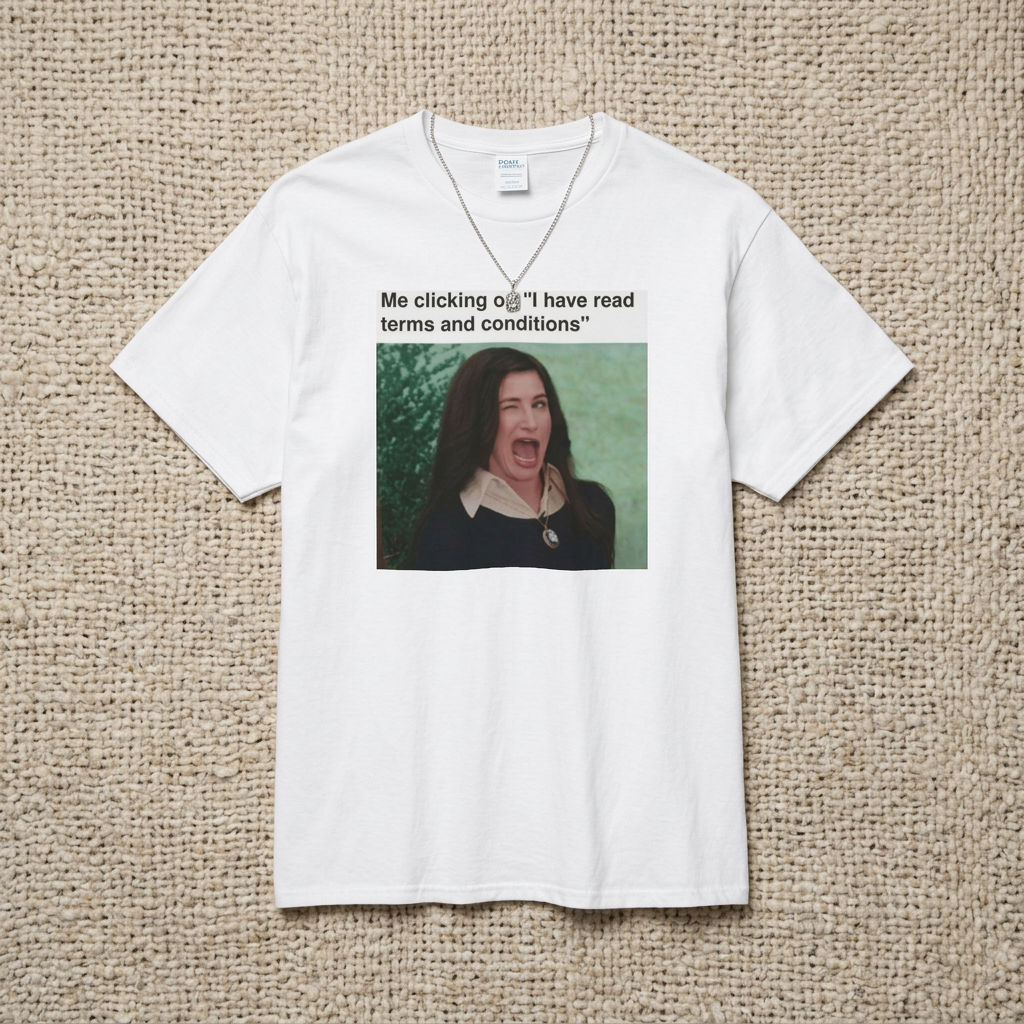 A white t-shirt with a graphic including a winking woman and text stating "Me clicking on 'I have read terms and conditions'" on a textured beige background